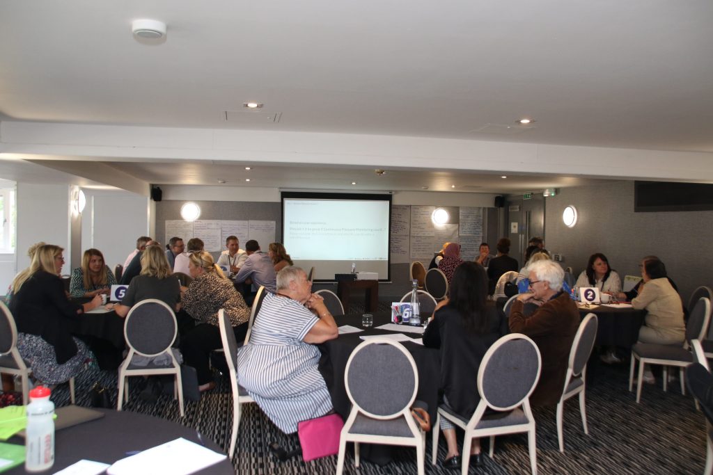 SEAMLESS Transforming Community Health Continuous Pressure Monitoring Workshop picture of delegates talking